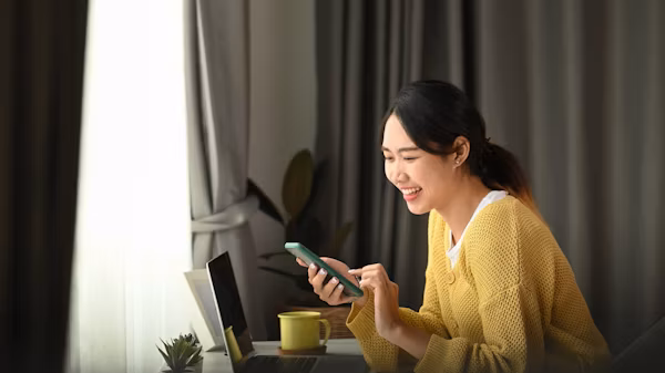 Someone holding a phone with a nurse on the other end using video call software.