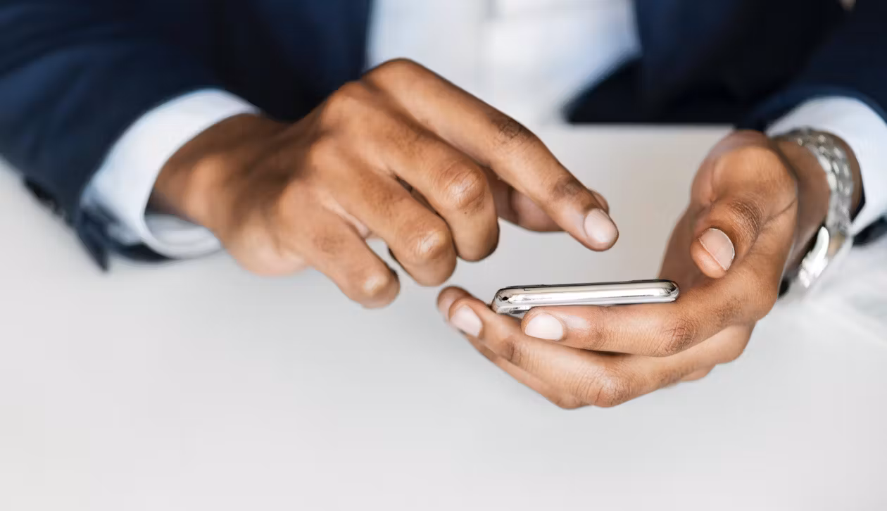 Hands holding a phone browsing the internet.